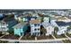 Aerial view featuring colorful two-story homes, landscaping, and a mix of light and dark roofs in a planned community at 2938 Salted Rim Rd, Kissimmee, FL 34747