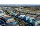 Aerial view of colorful homes with private pools, landscaping, and road with sparse traffic, promising a vibrant community at 2938 Salted Rim Rd, Kissimmee, FL 34747