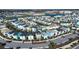 Aerial view of a community with colorful homes, landscaping, pools, parking areas, and a scenic water view at 2938 Salted Rim Rd, Kissimmee, FL 34747