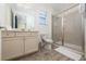 Clean bathroom featuring a glass-enclosed shower, modern vanity, and neutral tones at 2938 Salted Rim Rd, Kissimmee, FL 34747