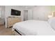 Bright bedroom featuring neutral tones, wood floors, and a mounted television at 2938 Salted Rim Rd, Kissimmee, FL 34747