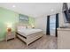 A bedroom with a neutral color scheme, wood-look flooring, and a comfortable bed at 2938 Salted Rim Rd, Kissimmee, FL 34747