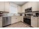 Bright kitchen featuring stainless steel appliances, wood-look flooring, and ample cabinet space at 2938 Salted Rim Rd, Kissimmee, FL 34747