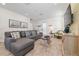 Cozy living room with sectional sofa, wood-look flooring, and nautical decor accents at 2938 Salted Rim Rd, Kissimmee, FL 34747