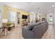 Bright, open living room with yellow walls, wood-look flooring, and comfortable seating at 2938 Salted Rim Rd, Kissimmee, FL 34747