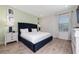 Comfortable main bedroom featuring a plush blue bed, neutral paint, wood floors, and bright natural light at 2938 Salted Rim Rd, Kissimmee, FL 34747