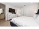 Bright main bedroom with a white dresser, television, and light wood-look floors at 2938 Salted Rim Rd, Kissimmee, FL 34747