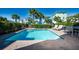 Inviting pool with lounge chairs and dining set for outdoor relaxation near beach homes at 2938 Salted Rim Rd, Kissimmee, FL 34747