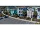 Street view showcasing colorful, modern two-story homes with balconies, parking, and lush landscaping, set in a community at 2938 Salted Rim Rd, Kissimmee, FL 34747