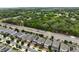 Aerial view of homes located alongside a wooded area with a road being constructed at 3084 Slough Creek Dr, Kissimmee, FL 34744