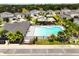 Aerial view of community pool, playground, cabana bordered by lush landscaping at 3084 Slough Creek Dr, Kissimmee, FL 34744