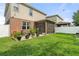 Spacious backyard featuring green grass, potted plants, a screened lanai and a white fence offering privacy at 3084 Slough Creek Dr, Kissimmee, FL 34744