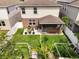 Aerial view of the backyard with a gazebo, patio, garden, and white fence at 3084 Slough Creek Dr, Kissimmee, FL 34744
