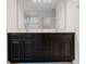 Bathroom featuring a double vanity with dark cabinets and a large mirror at 3084 Slough Creek Dr, Kissimmee, FL 34744