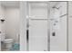 Bright bathroom featuring a tiled shower with a glass door, bench, and updated fixtures at 3084 Slough Creek Dr, Kissimmee, FL 34744