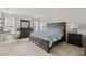 Spacious bedroom with a large bed, dresser, desk, and ample natural light at 3084 Slough Creek Dr, Kissimmee, FL 34744