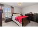 Bedroom showcasing a bed, dark wood furniture, and a window with curtains at 3084 Slough Creek Dr, Kissimmee, FL 34744
