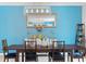 Bright dining room with modern lighting, wood table, blue accents, and an inviting atmosphere at 3084 Slough Creek Dr, Kissimmee, FL 34744