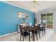 Bright dining room with modern light fixture, accent wall, and sliding glass doors to the patio at 3084 Slough Creek Dr, Kissimmee, FL 34744