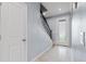 Light and airy entryway with tiled floors, staircase with wrought iron railing, and a glass panel front door at 3084 Slough Creek Dr, Kissimmee, FL 34744