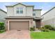 Two-story home with a brick driveway and meticulously landscaped yard at 3084 Slough Creek Dr, Kissimmee, FL 34744