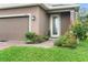 Close-up of home's front yard featuring a brick paver walkway, and colorful flower garden at 3084 Slough Creek Dr, Kissimmee, FL 34744