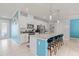 Bright kitchen with white cabinets, stainless steel appliances, granite countertops, and seating for four at 3084 Slough Creek Dr, Kissimmee, FL 34744