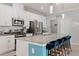 Beautiful kitchen featuring white cabinets, granite counters, stainless appliances, and seating for four at 3084 Slough Creek Dr, Kissimmee, FL 34744