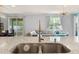 Open concept view from kitchen island to living room and dining area, with lots of natural light at 3084 Slough Creek Dr, Kissimmee, FL 34744