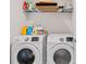 Laundry room featuring Samsung washer and dryer with shelving above for storage at 3084 Slough Creek Dr, Kissimmee, FL 34744
