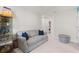 Neutral colored living room with a gray sofa, laundry, and storage space at 3084 Slough Creek Dr, Kissimmee, FL 34744