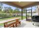 Screened patio with a wooden picnic table overlooking the landscaped backyard at 3084 Slough Creek Dr, Kissimmee, FL 34744