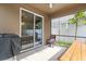 Covered patio features a seating area, grill, and a view of the fenced backyard at 3084 Slough Creek Dr, Kissimmee, FL 34744