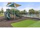 Community playground featuring slide, climbing structures, and safety turf at 3084 Slough Creek Dr, Kissimmee, FL 34744