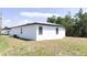 Side view of a well-maintained home with a spacious green backyard at 318 Cocoa Ct, Kissimmee, FL 34758