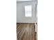 Light-filled bedroom with wood-look floors, a window, and white trim at 318 Cocoa Ct, Kissimmee, FL 34758