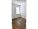 Clean, well-lit bedroom featuring wood-look flooring and bright white walls at 318 Cocoa Ct, Kissimmee, FL 34758