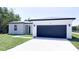 Charming single-story home featuring a modern garage door, freshly painted exterior, and a well-maintained lawn at 318 Cocoa Ct, Kissimmee, FL 34758
