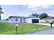 Attractive single-story home boasting a lush front yard, curbside mailbox, and a stylish, contemporary garage door at 318 Cocoa Ct, Kissimmee, FL 34758