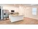 Bright, spacious kitchen featuring stainless steel appliances, a center island and hardwood floors at 318 Cocoa Ct, Kissimmee, FL 34758