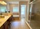 Bright bathroom with a soaking tub, tiled shower, dual sinks, and wood cabinetry at 3341 Pawleys N Loop, St Cloud, FL 34769
