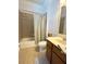 Bright bathroom featuring a shower-tub combo with tile surround, toilet, and single sink at 3341 Pawleys N Loop, St Cloud, FL 34769