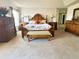 Spacious main bedroom with a decorative bed, bench, dressers, and bedside tables at 3341 Pawleys N Loop, St Cloud, FL 34769