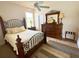 Comfortable bedroom featuring decorative iron bed frame, ceiling fan, and wooden dresser with mirror at 3341 Pawleys N Loop, St Cloud, FL 34769
