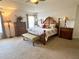 Spacious main bedroom with a decorative bed, bench, dresser, and bedside tables at 3341 Pawleys N Loop, St Cloud, FL 34769