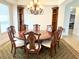Elegant dining room showcasing a round table, chandelier, and built-in shelves at 3341 Pawleys N Loop, St Cloud, FL 34769