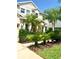 Beautiful front yard with tropical landscaping and a well-maintained lawn at 3341 Pawleys N Loop, St Cloud, FL 34769