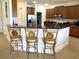 Kitchen area with bar seating and stainless steel appliances at 3341 Pawleys N Loop, St Cloud, FL 34769