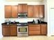 Well-appointed kitchen with stainless steel appliances and wood cabinets at 3341 Pawleys N Loop, St Cloud, FL 34769