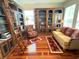 Cozy library featuring custom bookshelves, hardwood floors, and comfortable seating at 3341 Pawleys N Loop, St Cloud, FL 34769